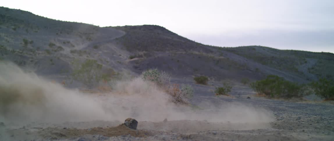 A person is riding a dirt bike in a desert area