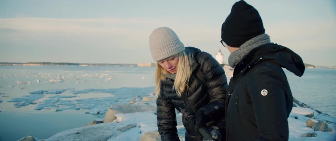 Two photographers prepare for a winter landscape photograph