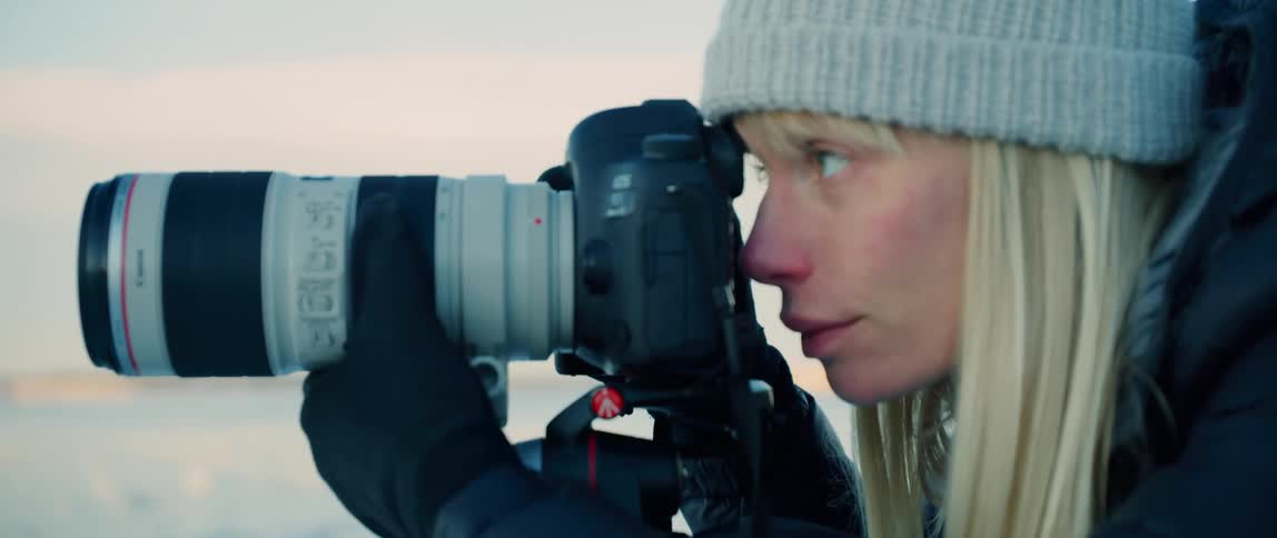 A photographer leans in to take her photograph