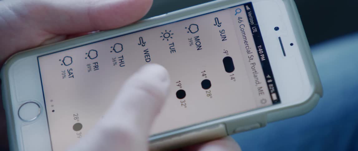 Scrolling through a weather app on a mobile phone