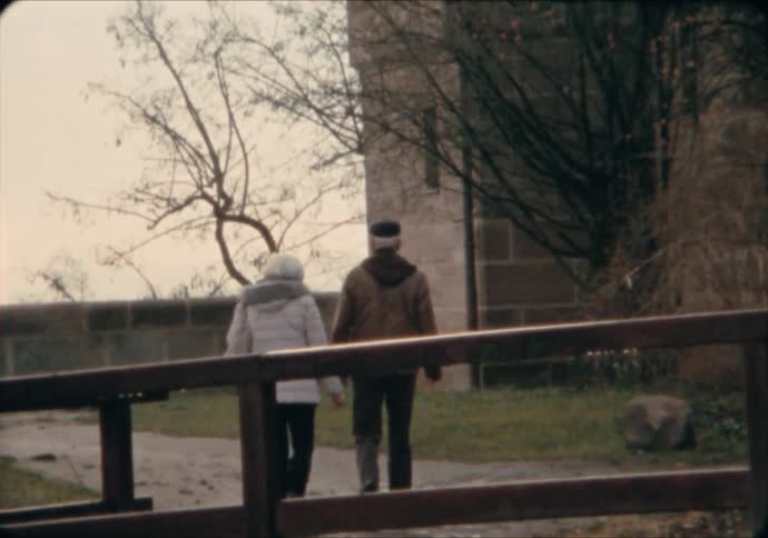 An elderly couple walks along a path in the Imperial Castle grounds of Nuremburg