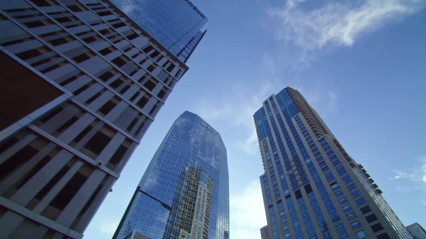 Sunlight shines behind skyscrapers in a city