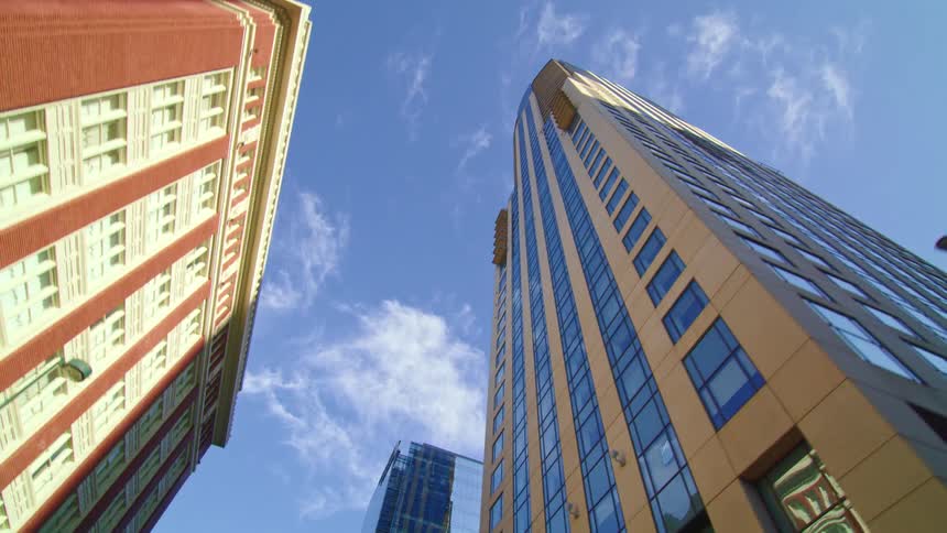 Skyscrapers line a city street during the daytime
