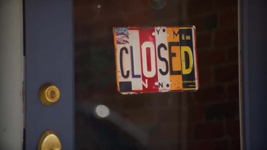 Colorful and creative closed sign hanging on the glass door of a store