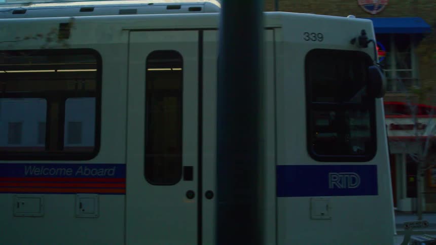 A public train is moving through a city