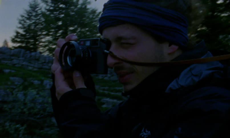 A man is taking photographs on a windy day