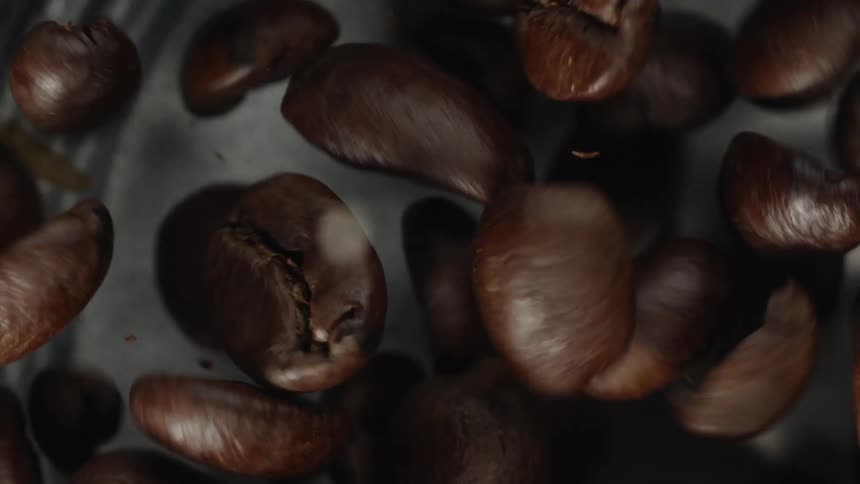 Coffee beans being mixed around by a machine