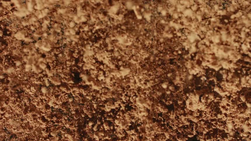 Broken pieces of chocolate and bits of chocolate falling