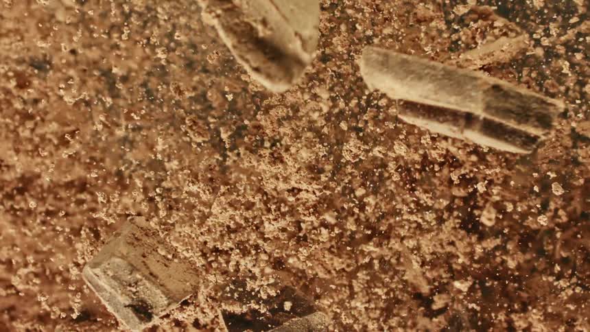 Brown and black colors that look like chocolate and chocolate dust falling