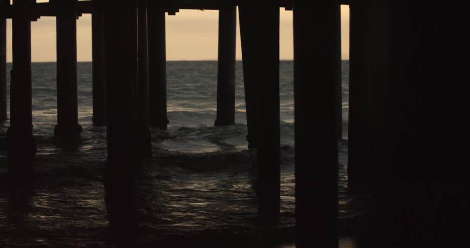 Waves rolling around pier supports