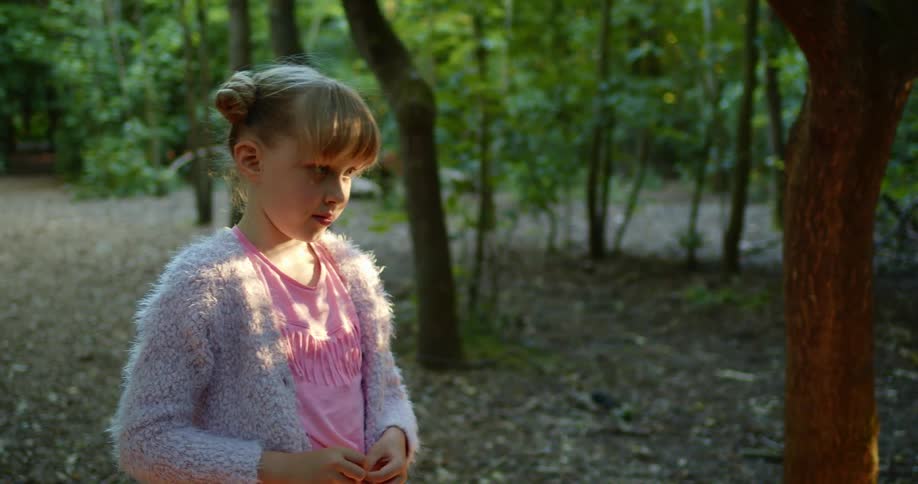 A girl walks around the forest