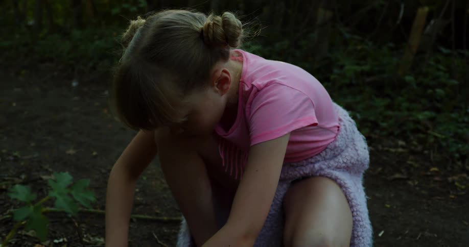 A child is digging in the dirt
