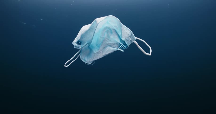 Surgical mask floats under the waters surface