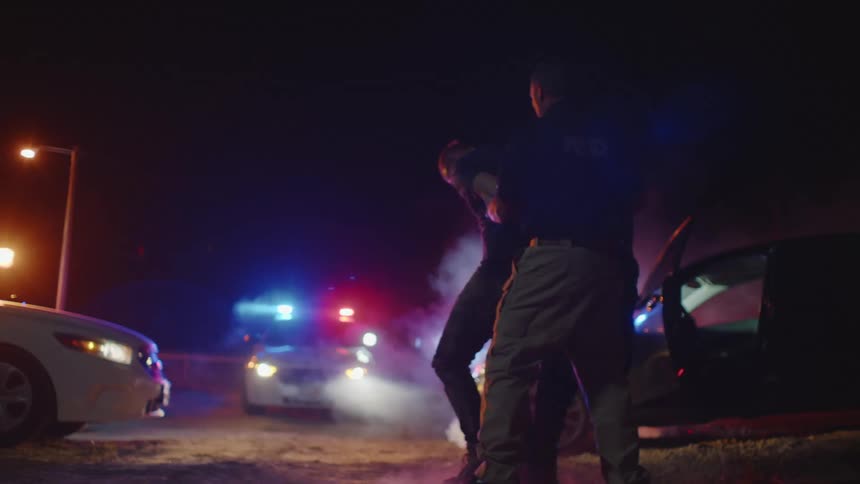 Police drag a man off in handcuffs