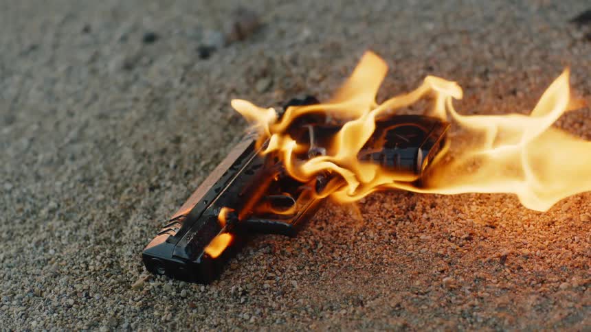 A firearm is set on fire outdoors