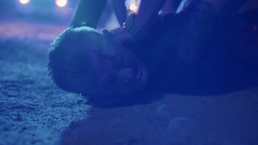 Police hold a man down on the ground