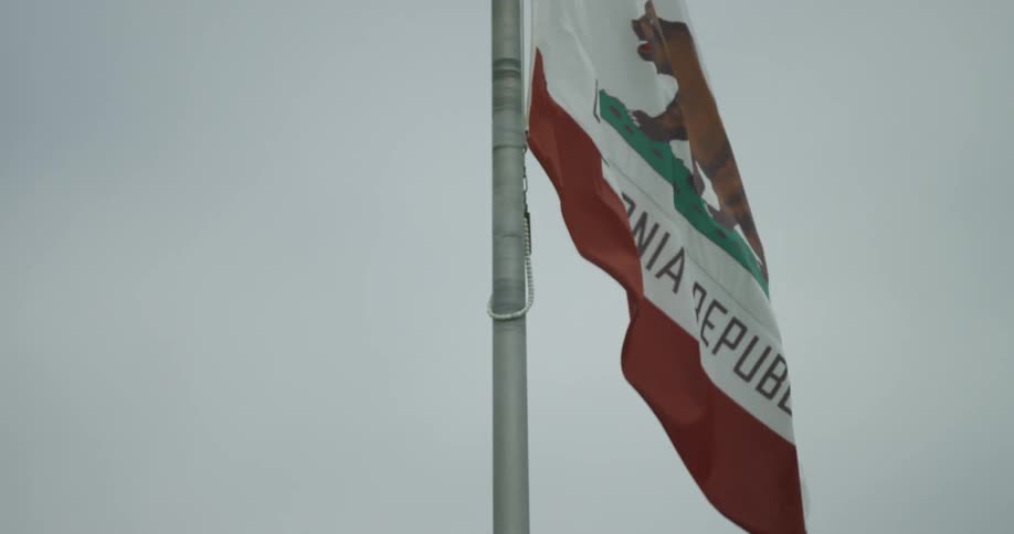 The california flag moves in a breeze on a cloudy day