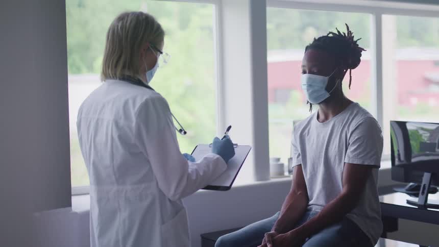 A doctor is talking to a patient in a hospital