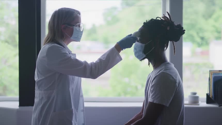 Doctor examines patient with device
