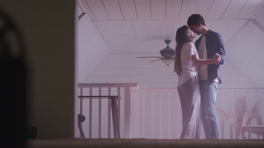 A man and woman dance in the room