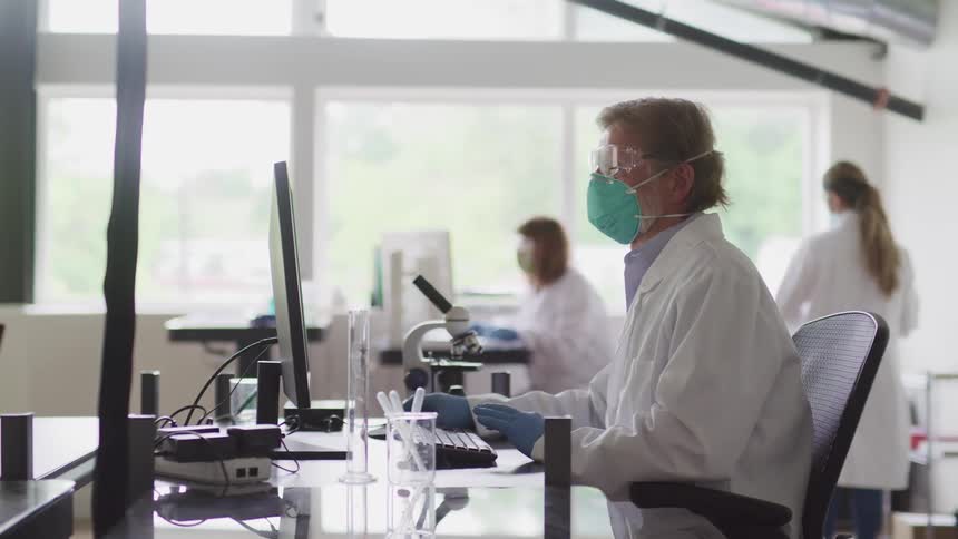 Scientists work in the lab at desks