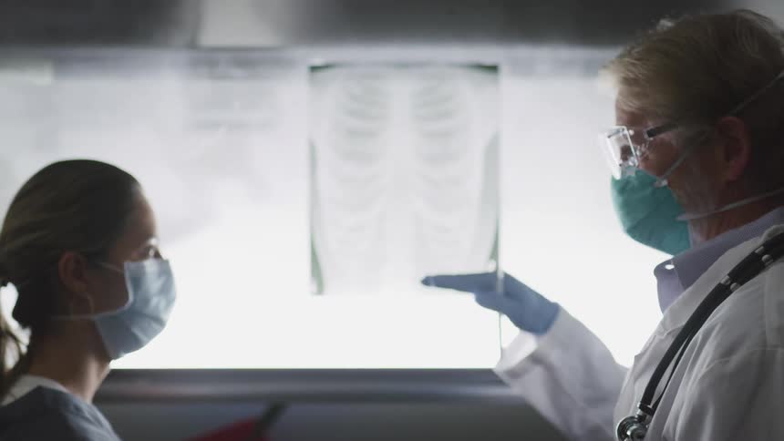 Two doctors are examining an xray
