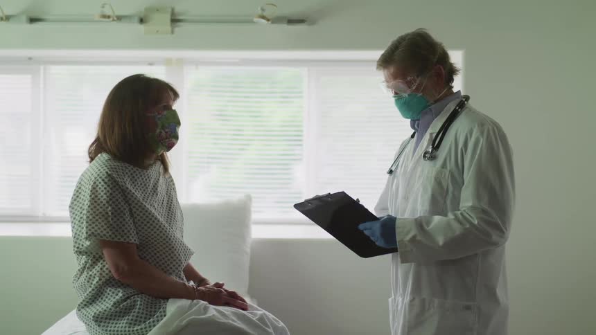 A patient in a clinic talks with a doctor