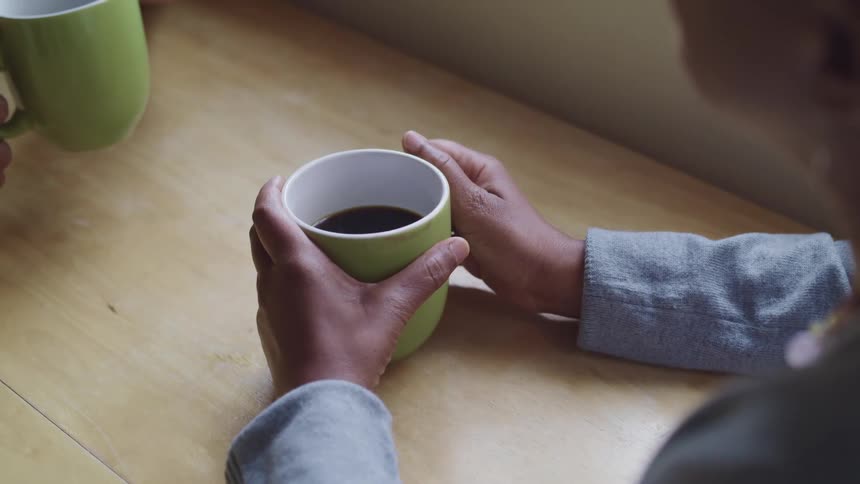 Two people are drinking coffee at the table
