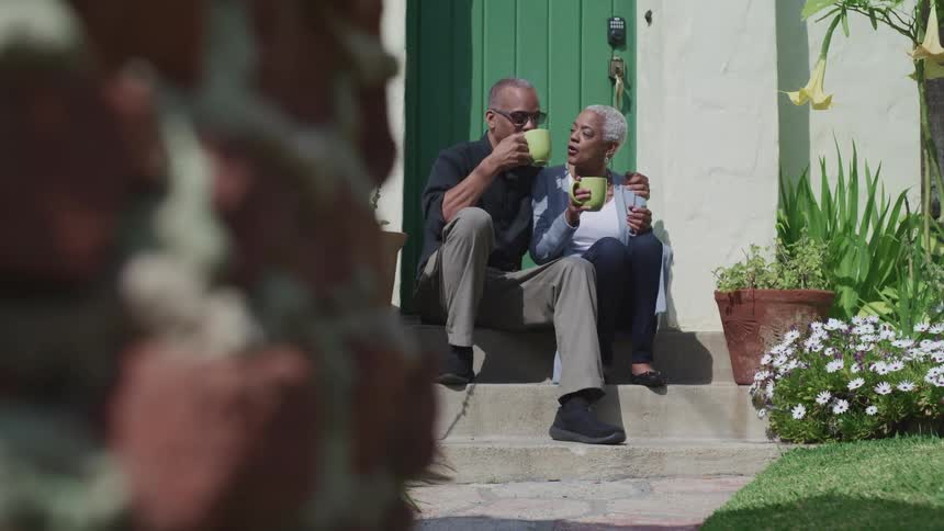 A man and woman are sitting outdoors together
