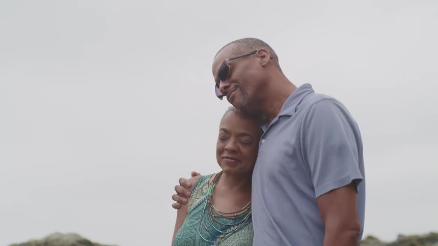 A man and woman hug outside