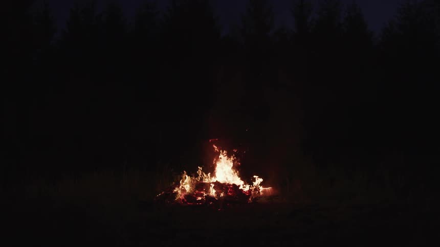 A bonfire burning at night