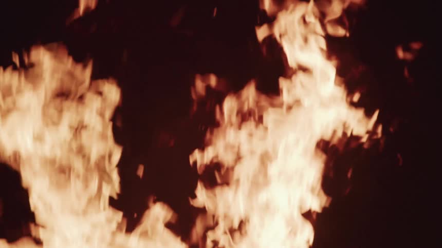 Orange flames rising in the air at night