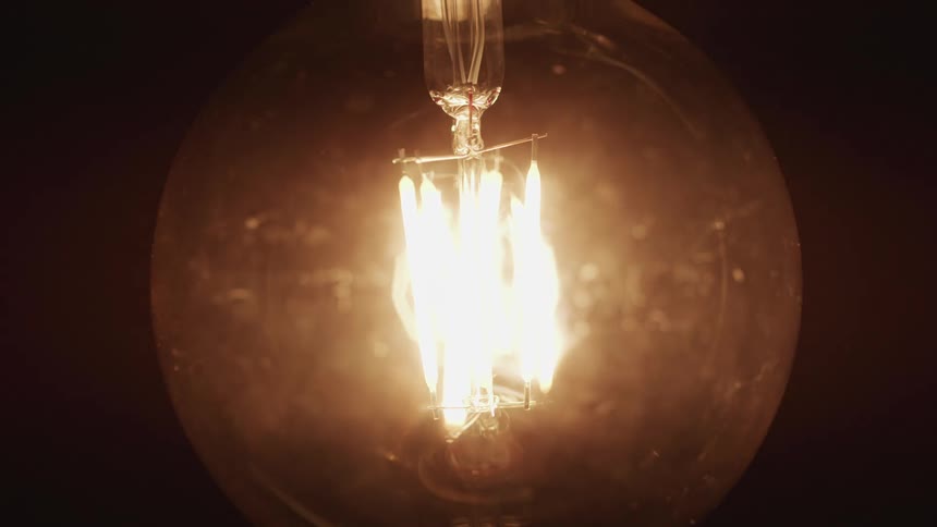 The bulb blinks on and off in the dark