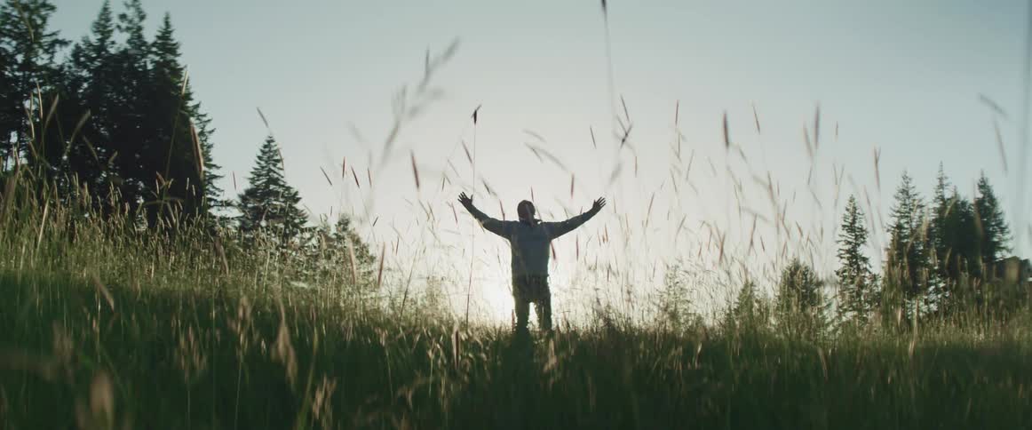 A man is raising his arms on the field