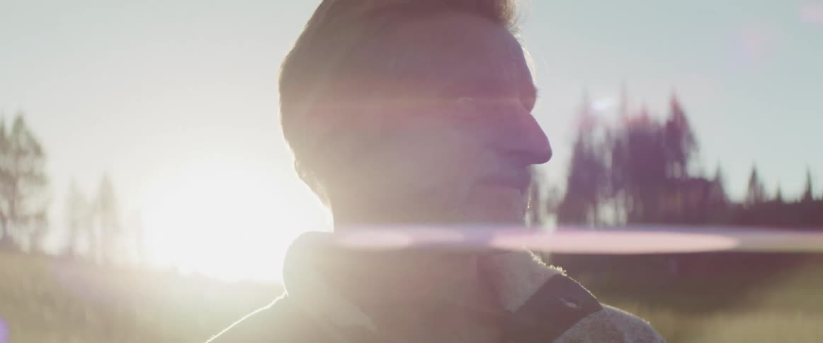 A man is hiking in the wilderness at dusk
