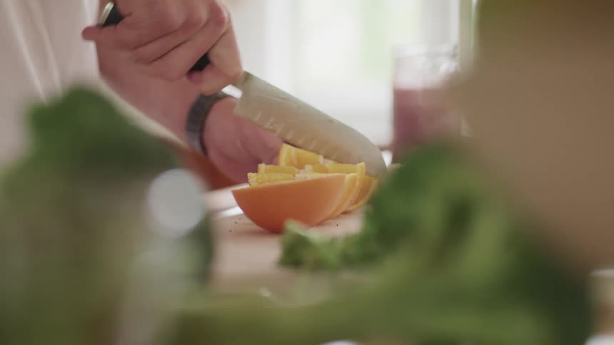 A man is preparing food in a kitchen