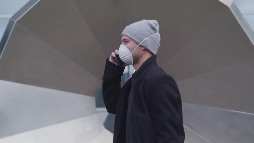 A man is walking through a downtown city