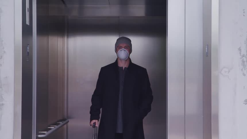 A man is riding the elevator