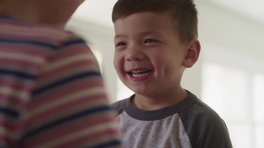 A mother and son have fun at home