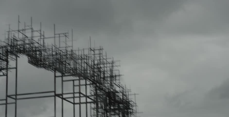 View of scaffolding in an urban area on a cloudy day