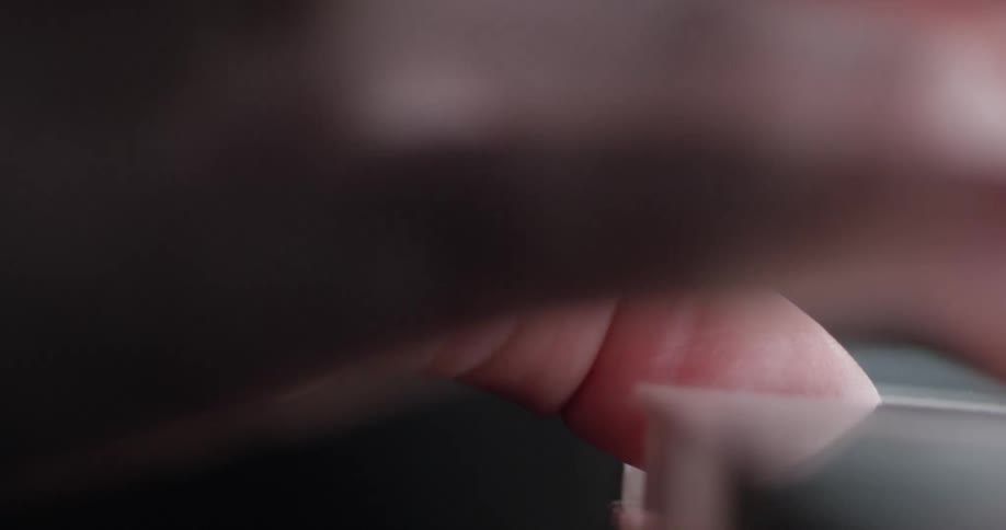 A person begins playing the piano keys
