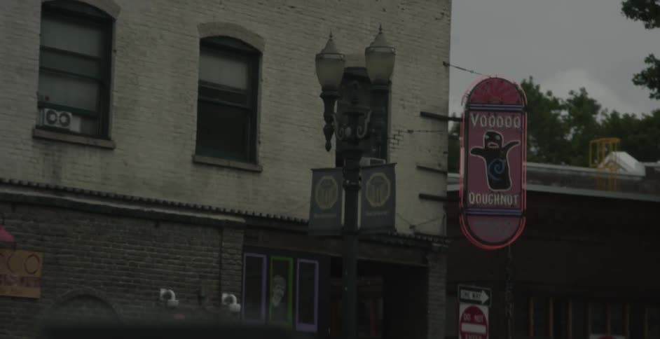 A vehicle drives by a building
