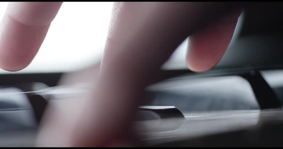 Fingers press piano keys