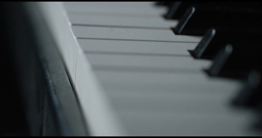 A light shines on piano keys