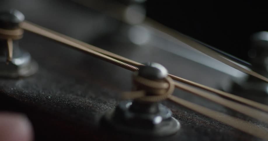 Fingers hold a guitar head