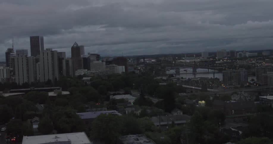 The skyline and buildings of a medium-sized city during the evening on a cloudy day