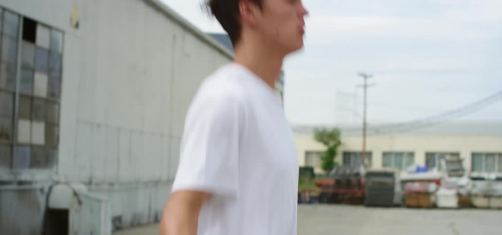 Man jumps rope in warehouse parking lot