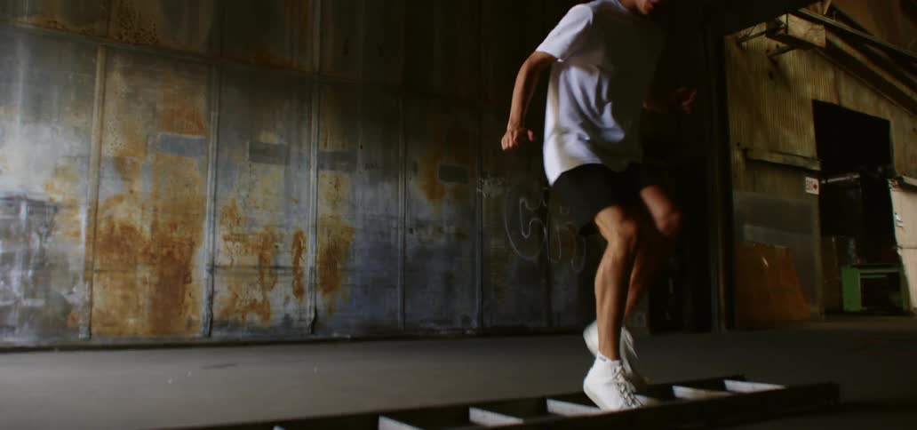 A male caucasian jogging using an exercise ladder