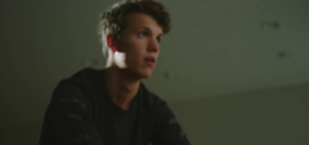 A guy is exercising on a bike indoors