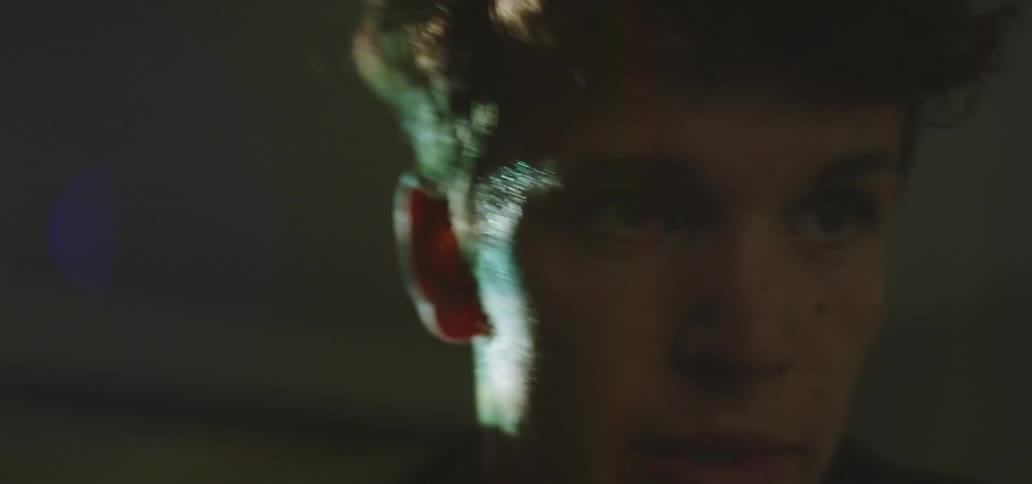 A man in a room with a black shirt working out with a light in the background